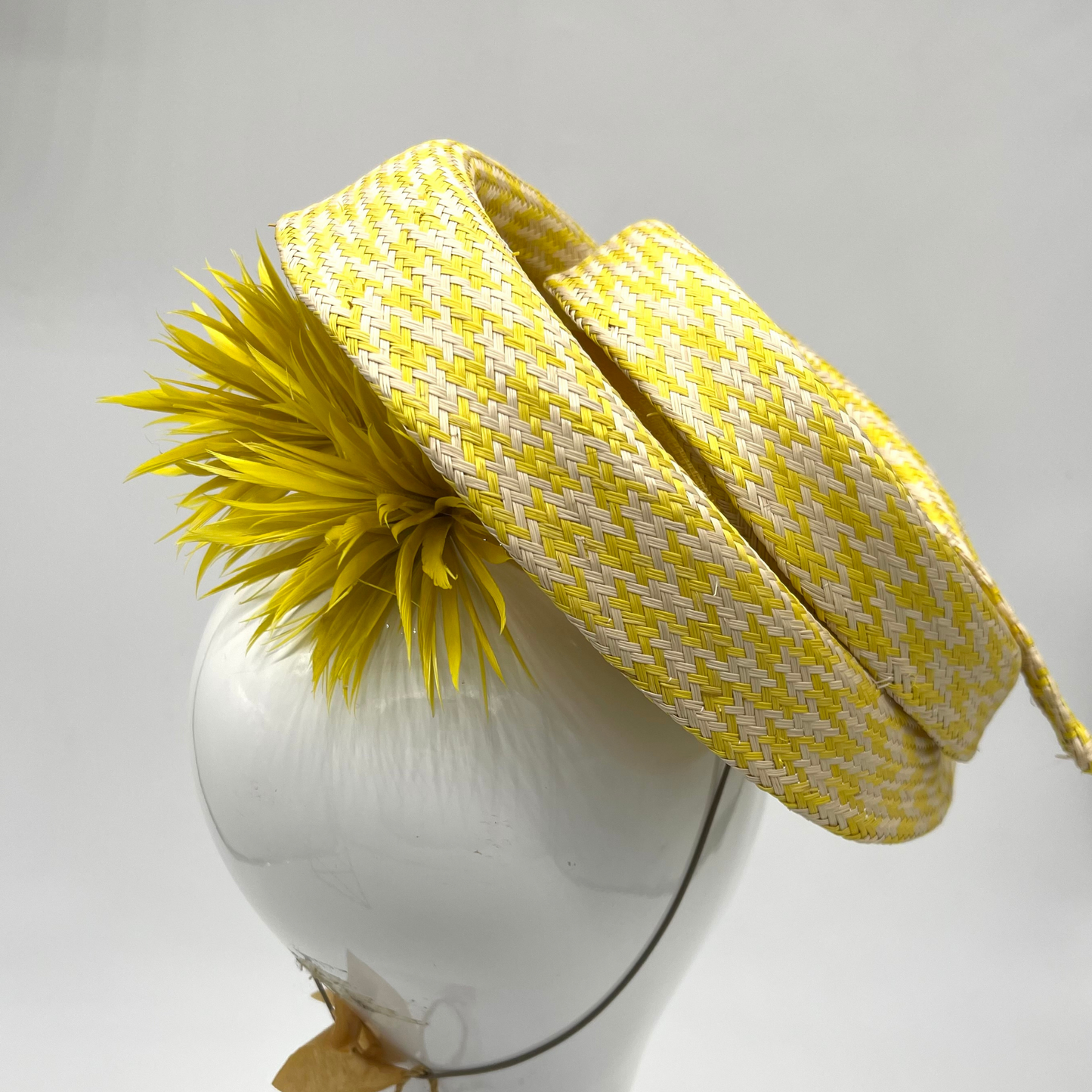 Yellow and white spiral hat with yellow goose biot pom poms