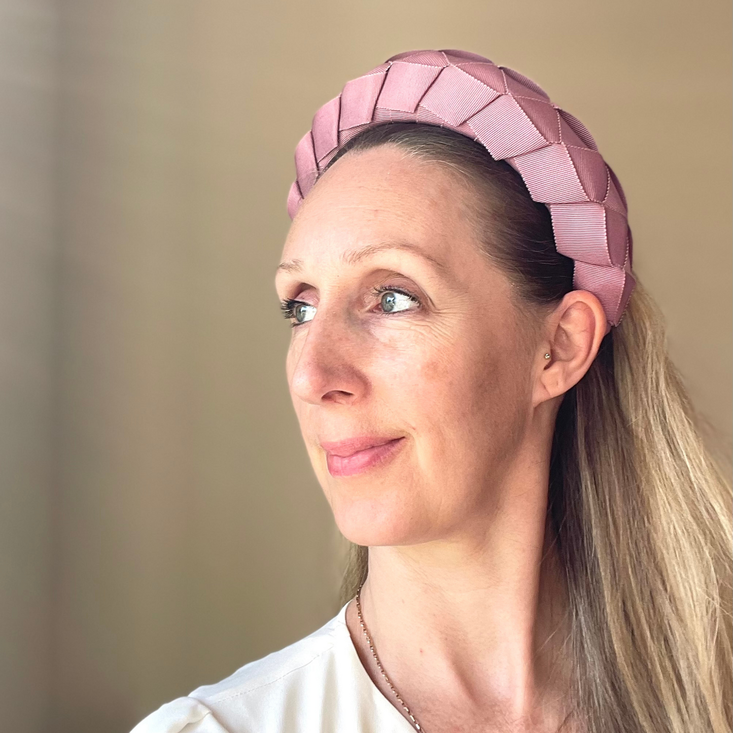 wearing a pink woven ribbon headband
