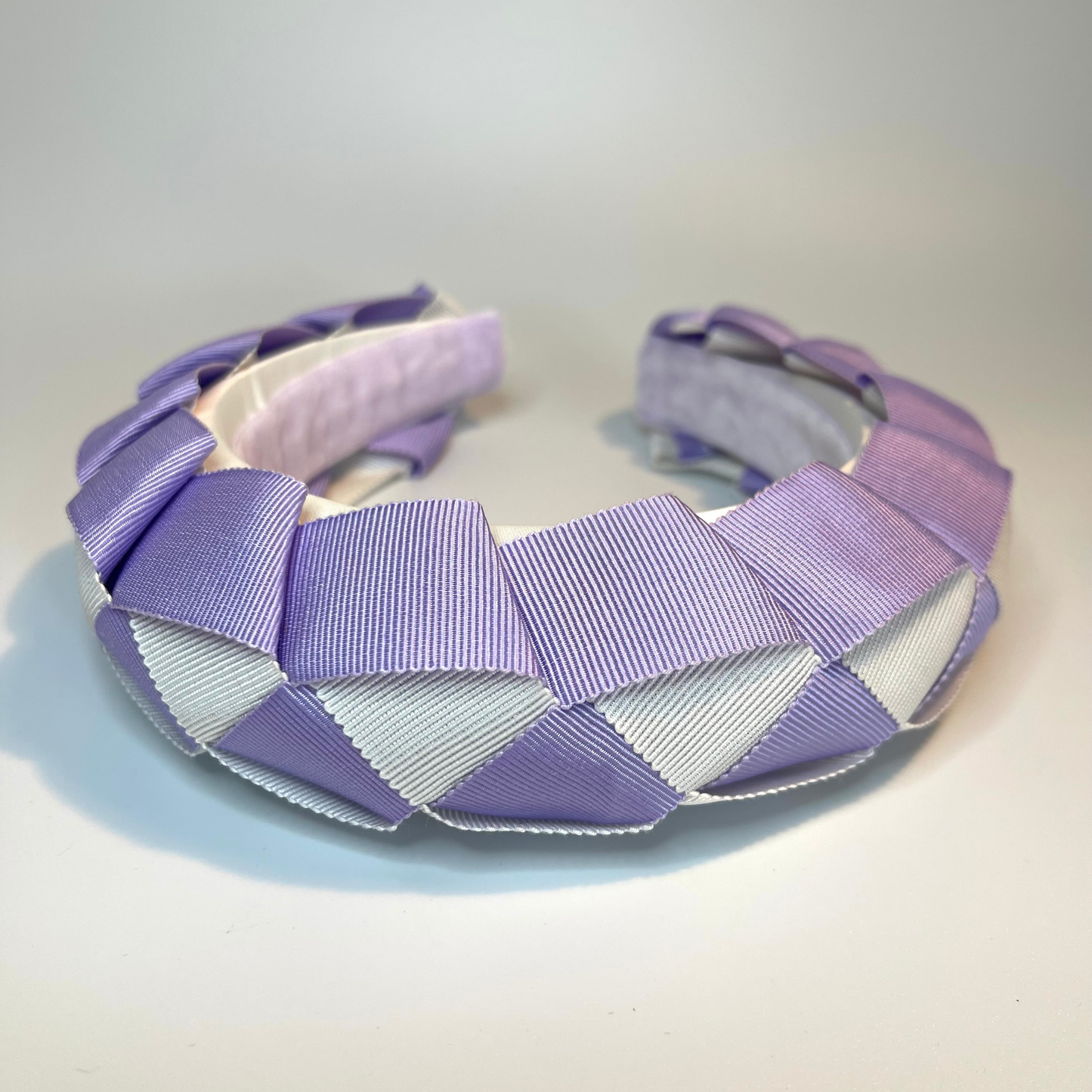 lilac and white woven ribbon sitting on a padded headband