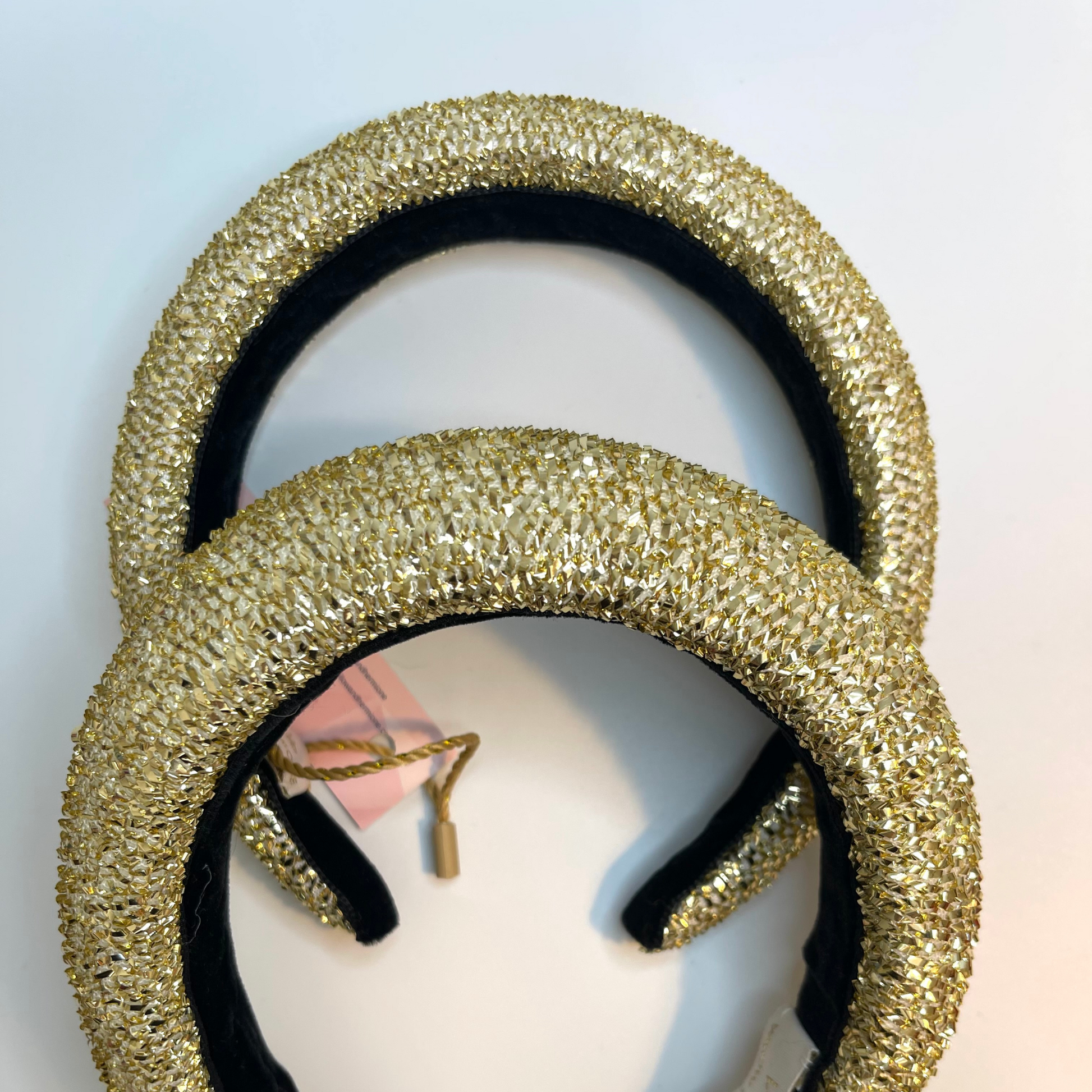 Gold tinsel padded headbands in 1 inch and 1/2 inch lined with black velvet ribbon.