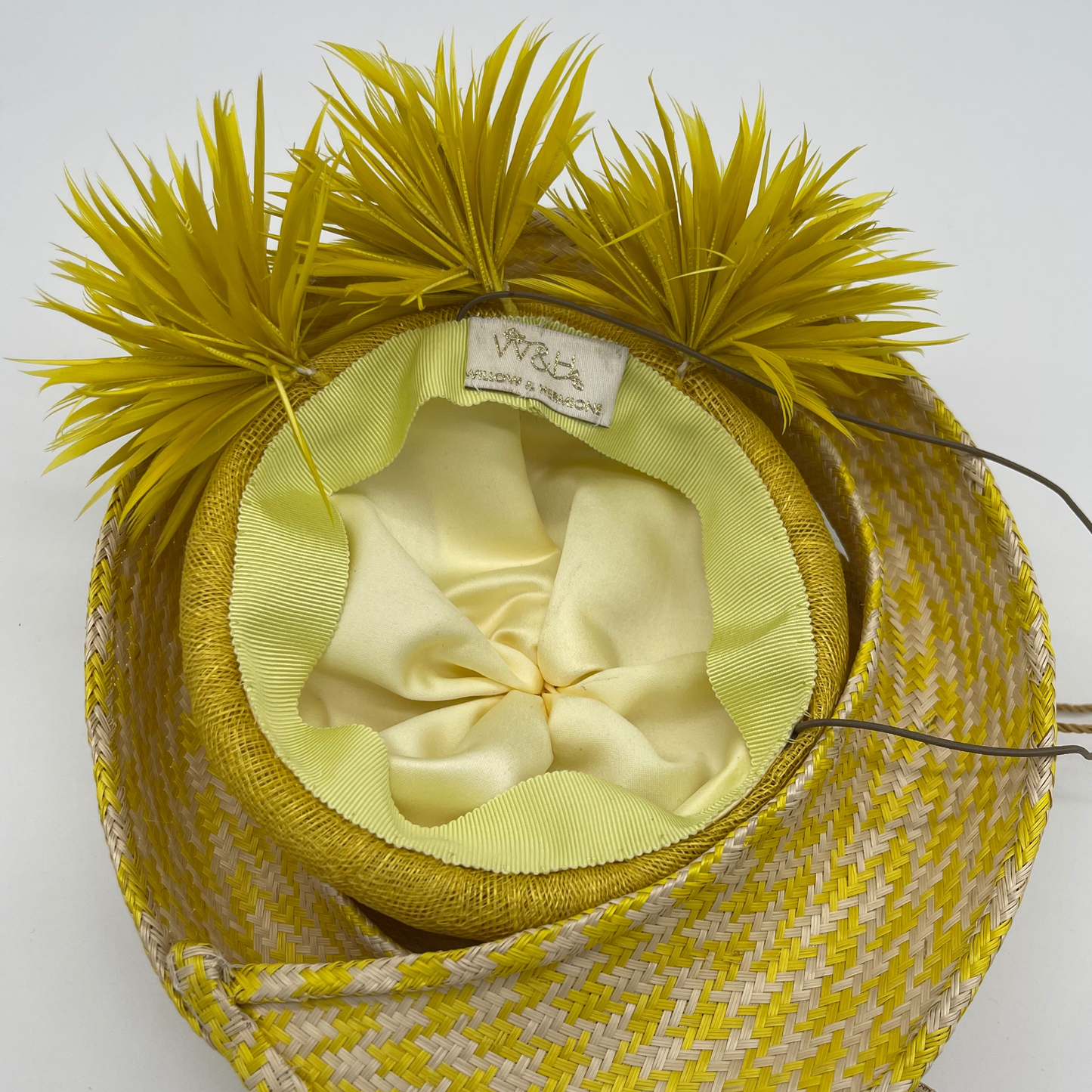 Yellow and white spiral bat with three yellow goose biot pom poms lining